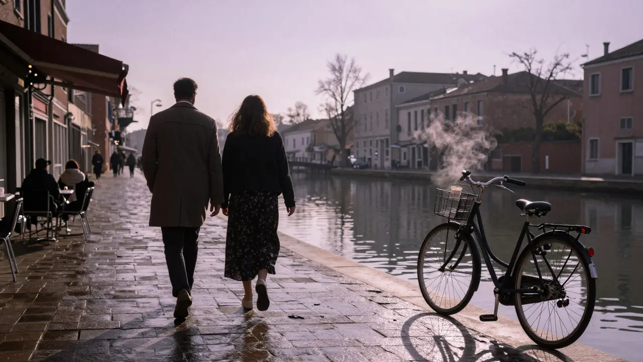 Two individuals walking along the Navigli canal at dawn, their shadows long on wet cobblestones under a soft sky.