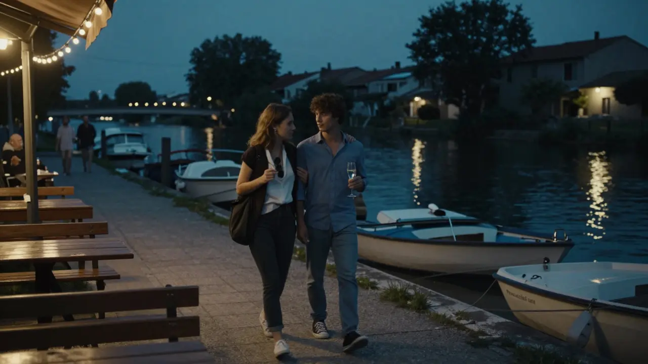 A couple walking along a lit canal at night, holding drinks as string lights reflect on the water in quiet Milan.