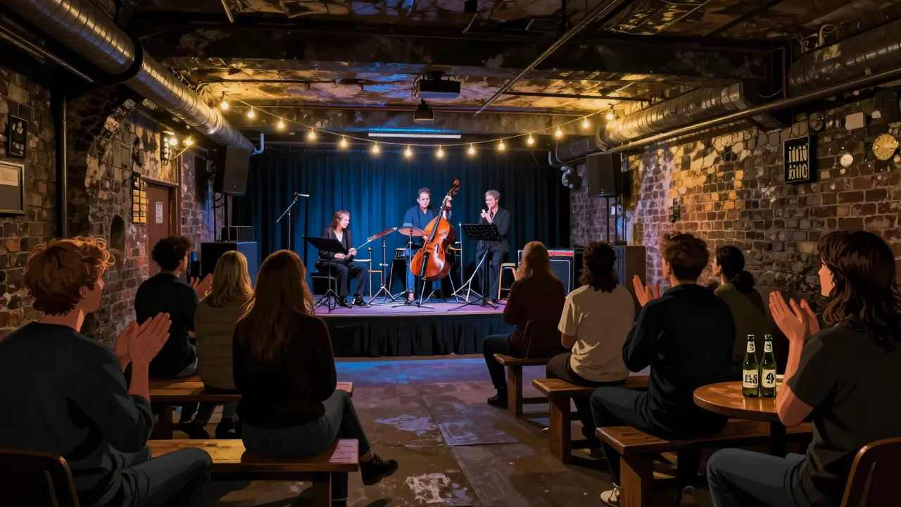 A small live music performance in a basement venue with audience seated on the floor.