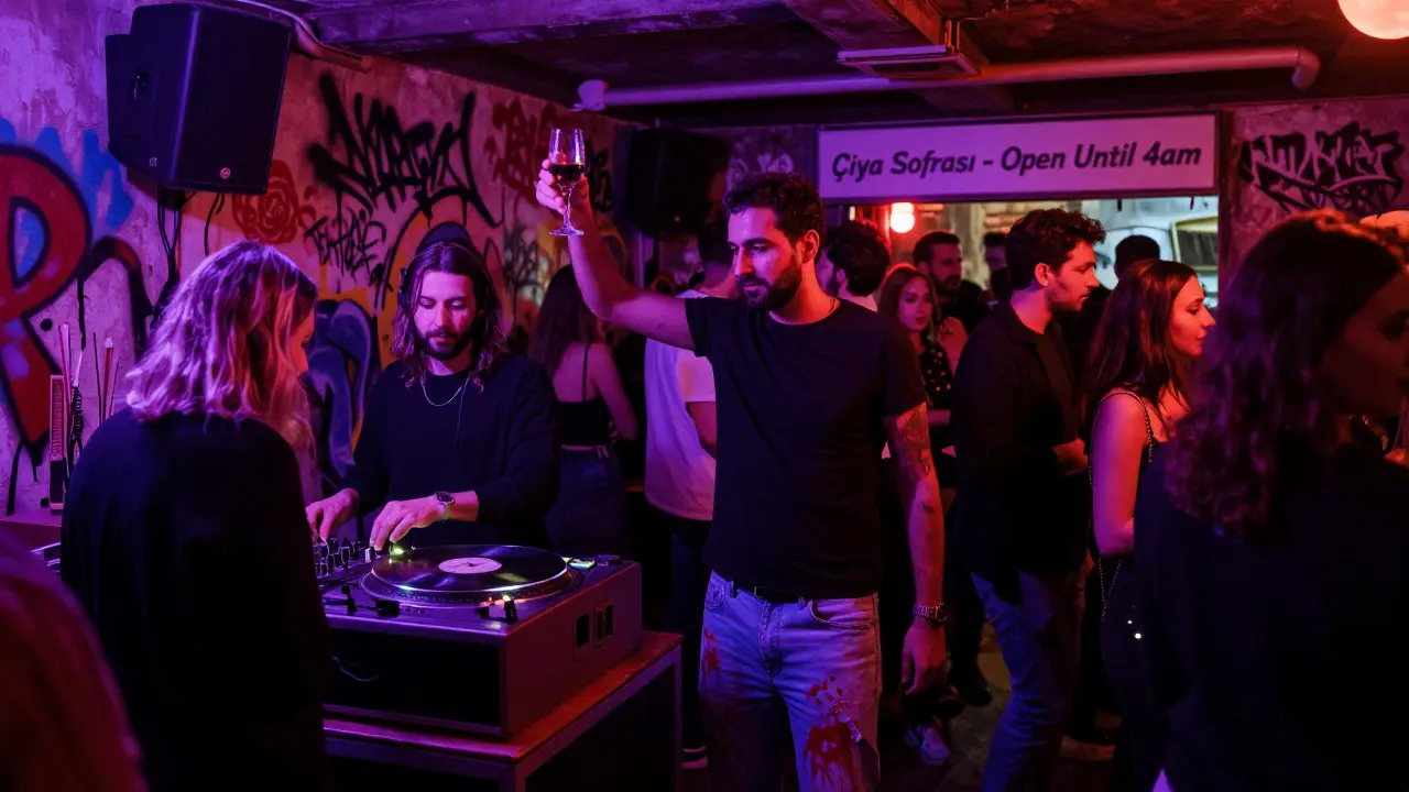 Vibrant underground club in Kadıköy with graffiti walls and crowd dancing to live music.